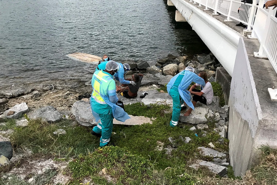 Two men pulled out of lagoon  after capsizing in their dinghy