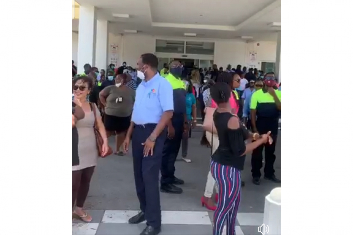       Labour union members gather en  masse outside government building   