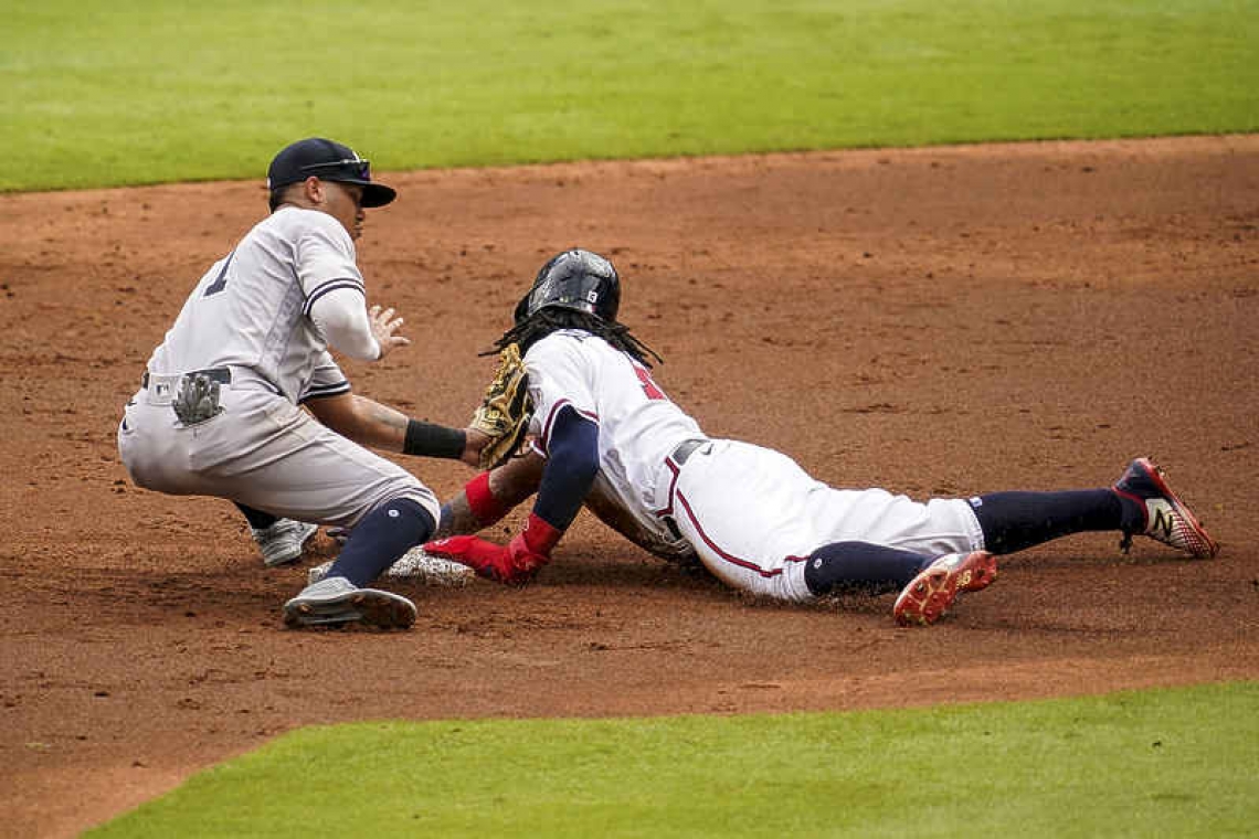 Braves hit three homers, snap Cole's 20-game win streak
