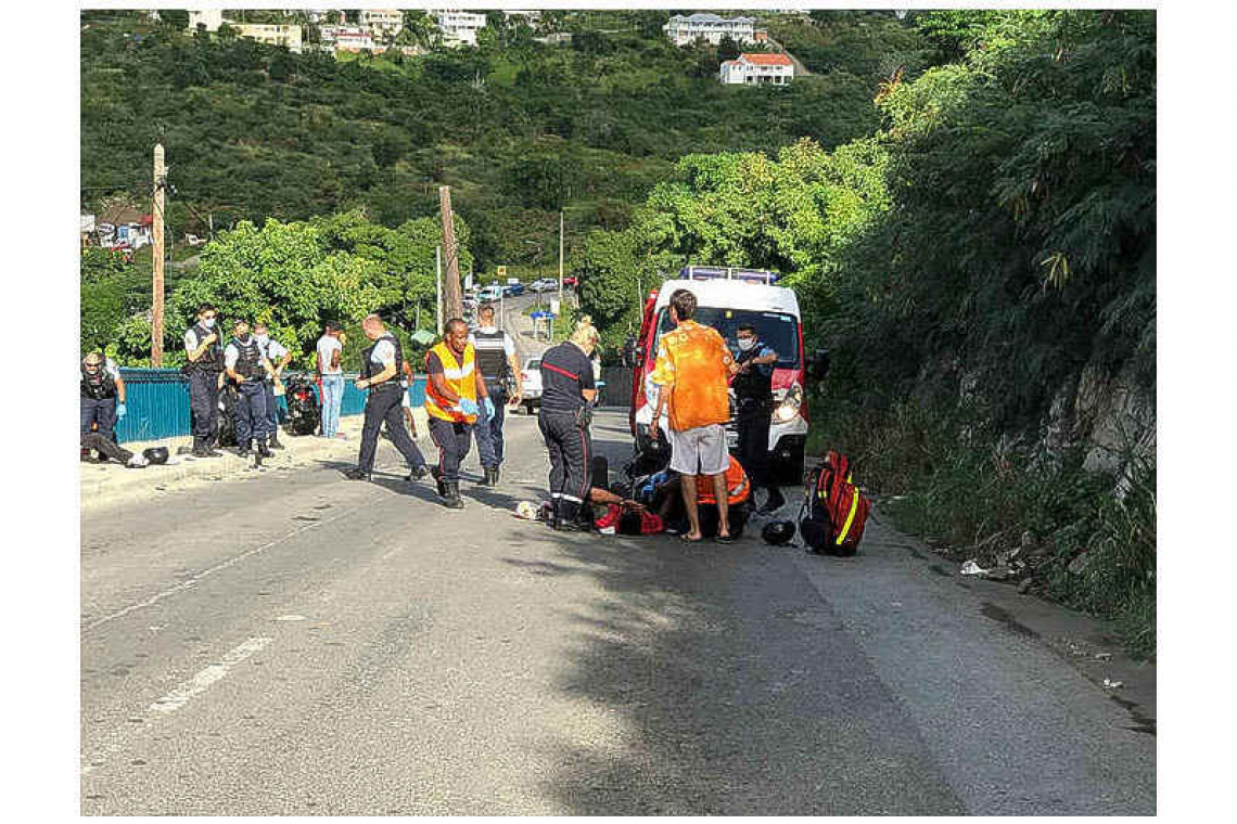 Two scooter riders collide while  overtaking cars on Morne Valois