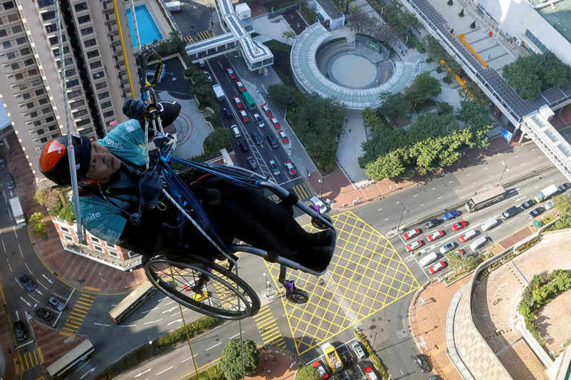 In wheelchair, paraplegic Lai Chi-wai climbs up skyscraper in Hong Kong