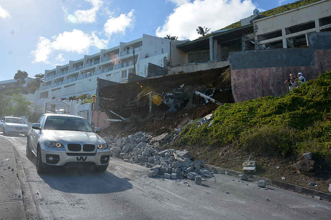 Retaining wall collapses on  road, none hurt in accident