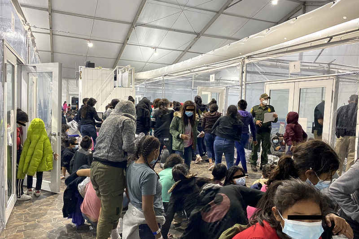 Inside border facility, migrants crowd together, new photos show