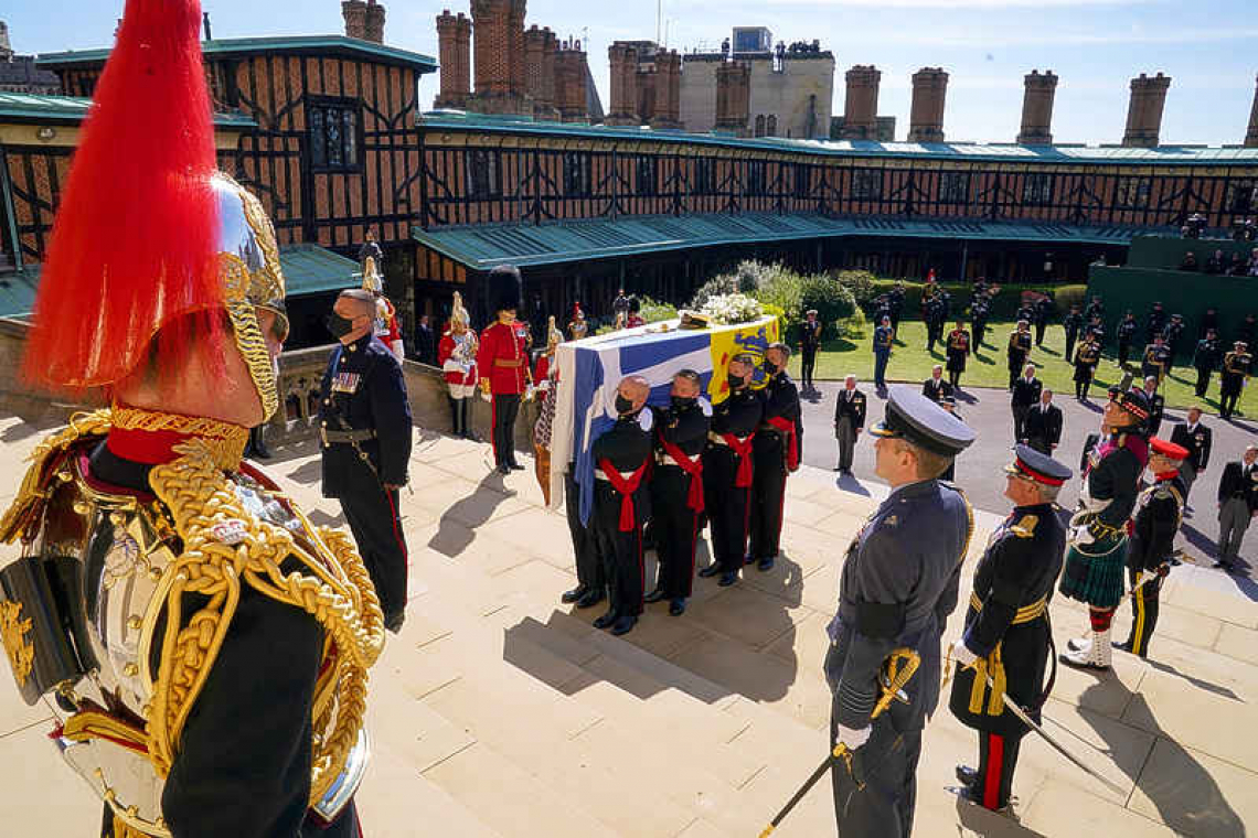 Queen Elizabeth stands alone as Philip is laid to rest