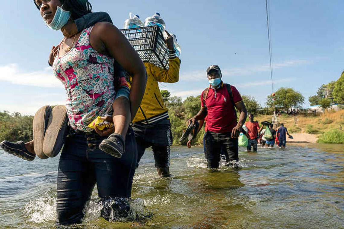 Thousands of migrants converge under bridge, posing new challenge for Biden