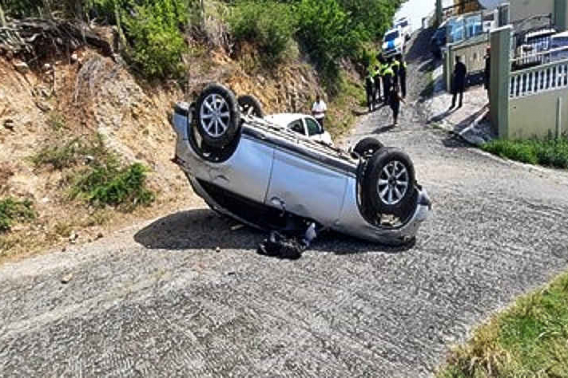 Car flips over on  Little Bay hillside