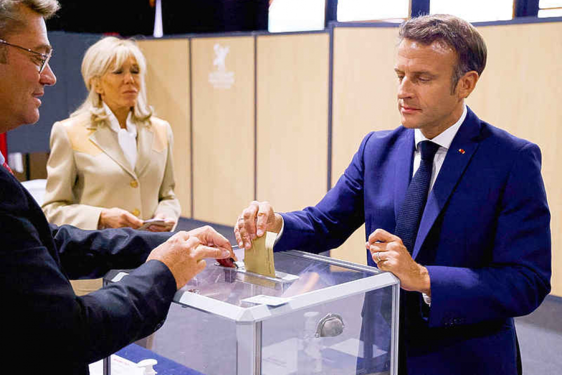 Macron faces tough battle for control of parliament after first round vote