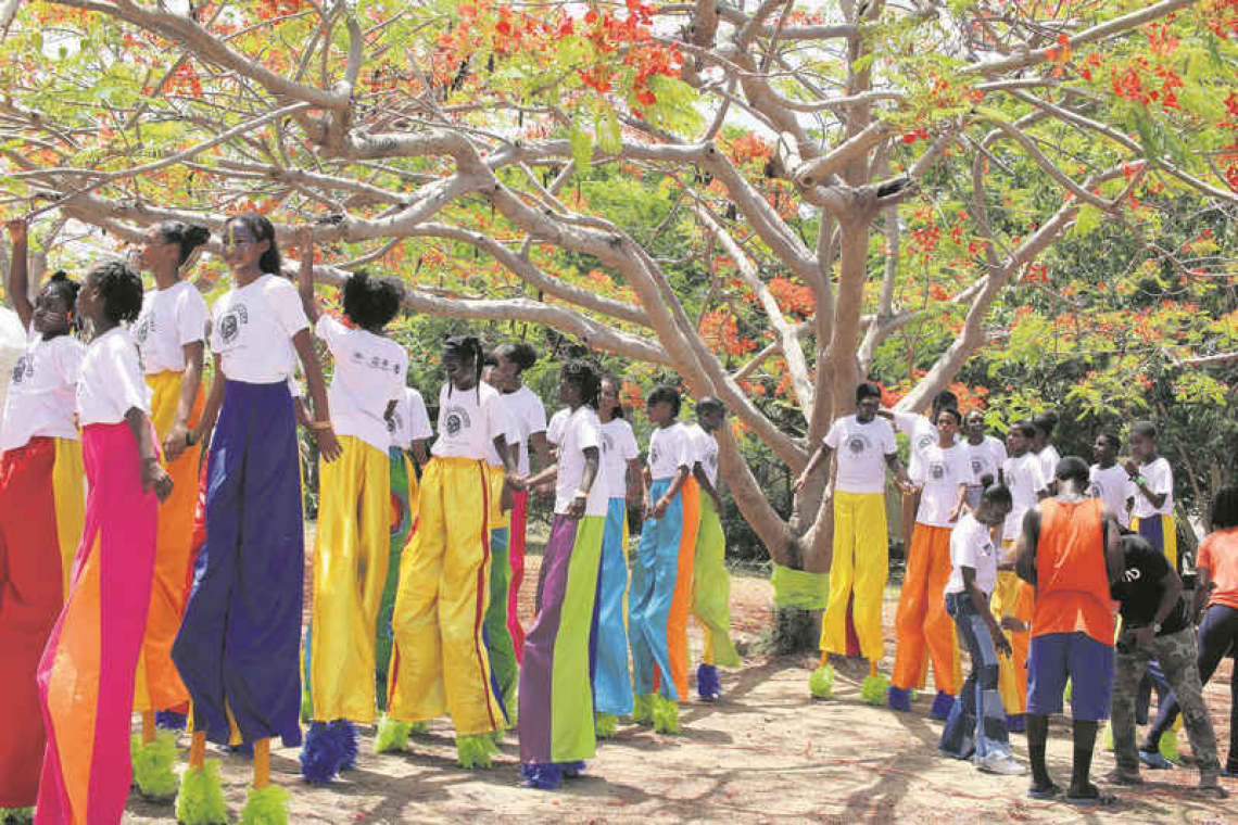 Kids and the Soualigan Giant Moko Jumbies!