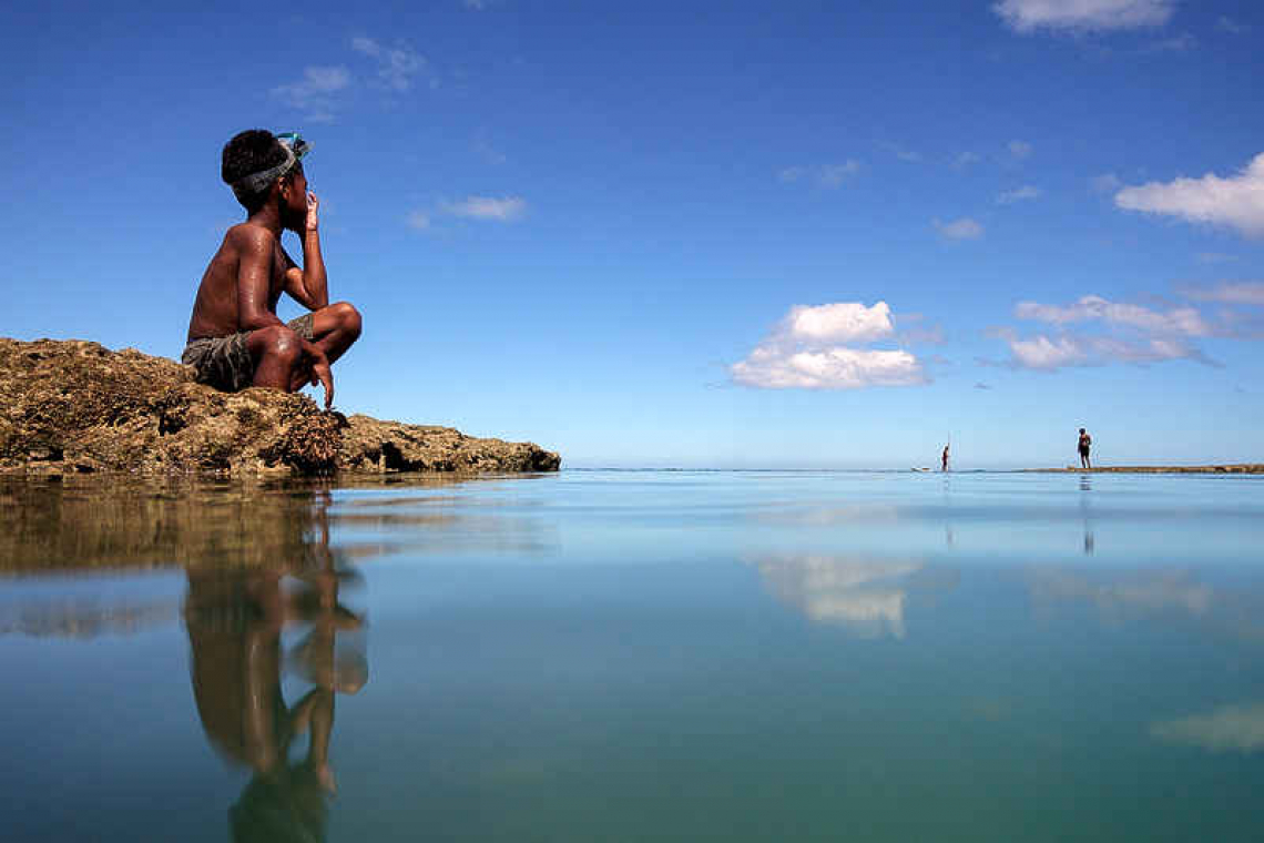 Fiji, moving villages inundated by rising seas, wants big emitters to pay