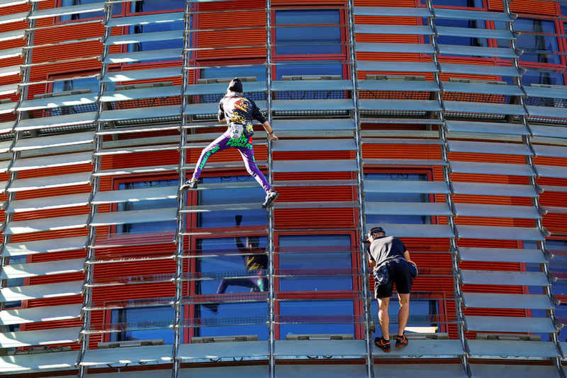 'French Spiderman' climbs first skyscraper with son in Barcelona