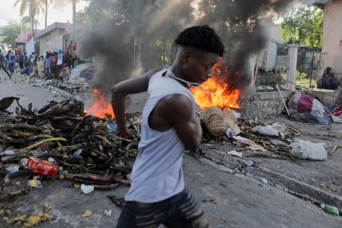    Haitian police fire tear gas as thousands protest against govt.