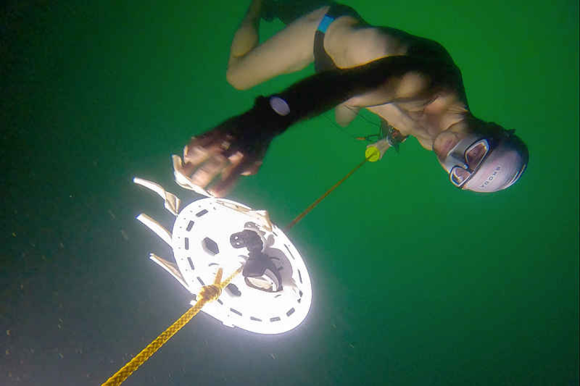 Free-diver plunges to a record depth beneath frozen Swiss lake