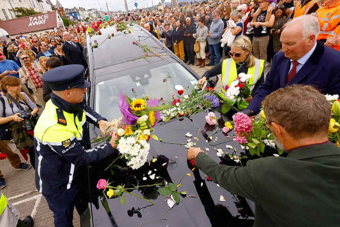 Fans bid seaside farewell to Sinead O'Connor with songs, flags and flowers 