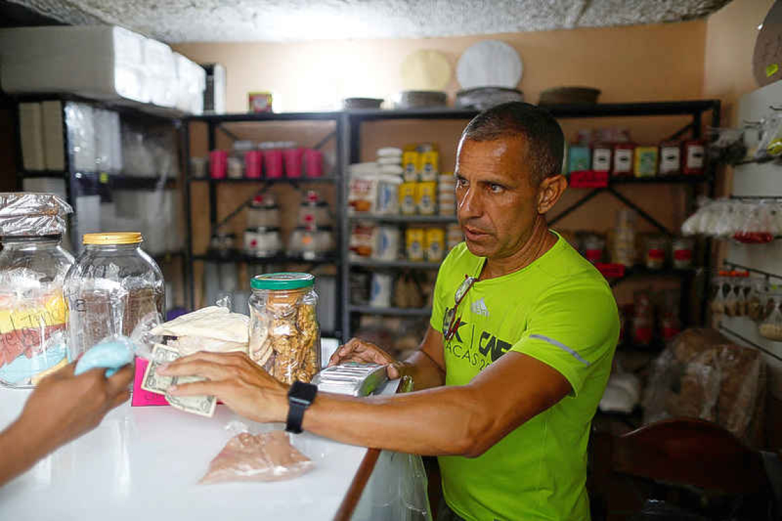 Venezuelans lament end of brief dollarization boost