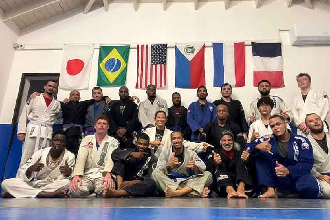 Three Brazilian Jiu Jitsu students earn blue belts