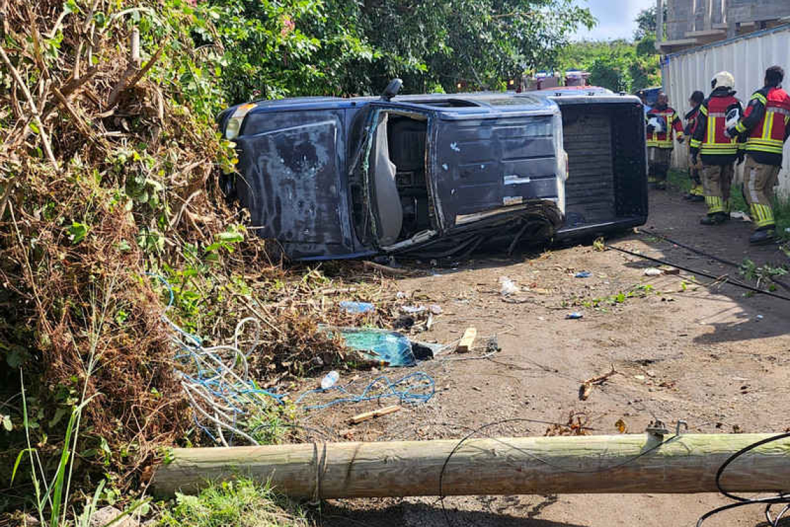 Pick-up truck lands on its side  after hitting an electrical pole