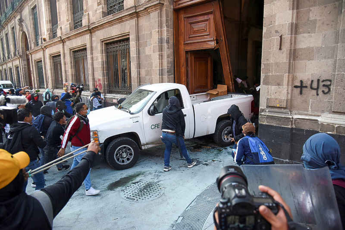 Protesters knock down door of Mexico's presidential palace