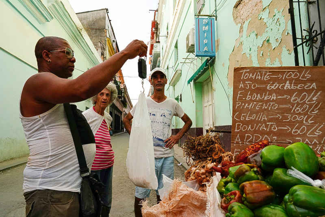 Cubans await promised government  intervention as peso slides further