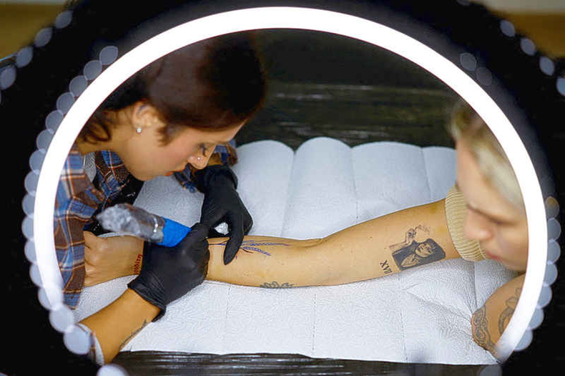 Ukrainians turn to tattoos  to ease the grief from war