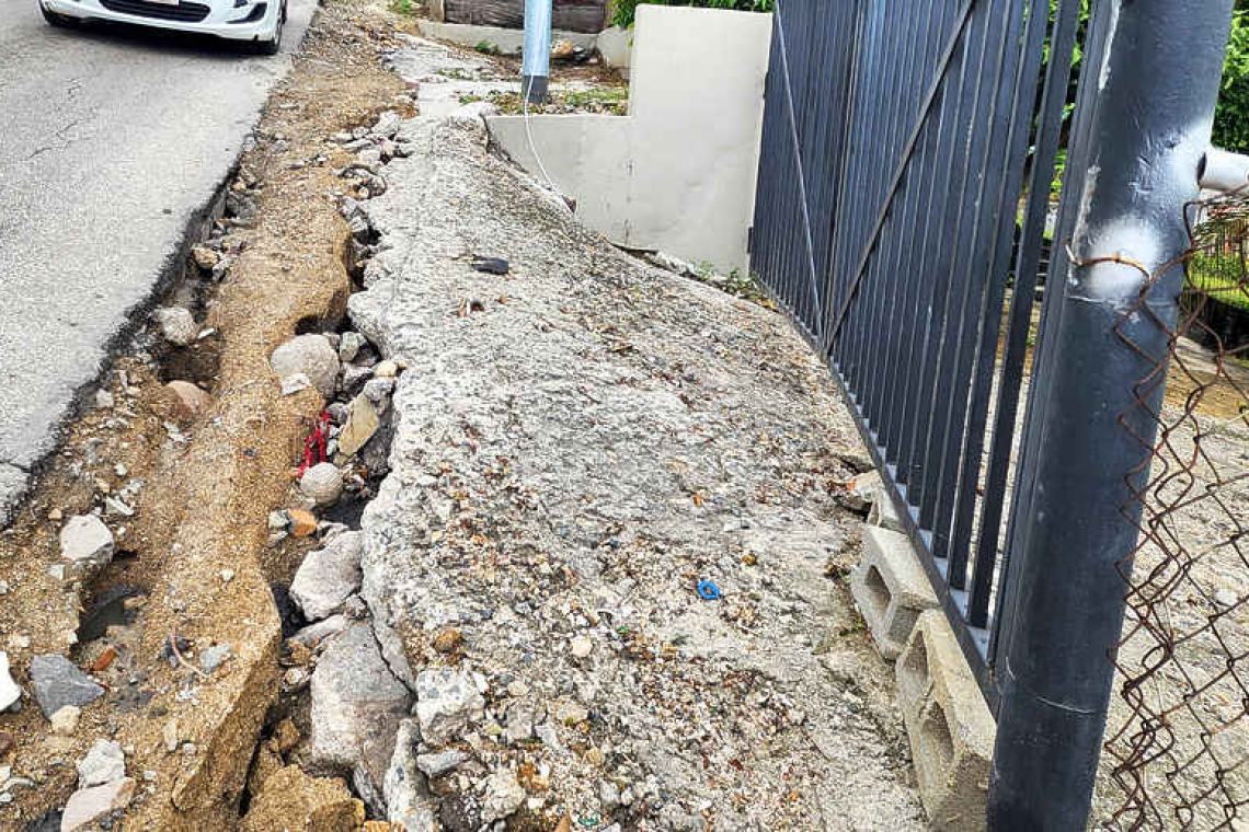 Rain washes away poorly-restored roadside, causing  access problems for Mount Willem Hill residents