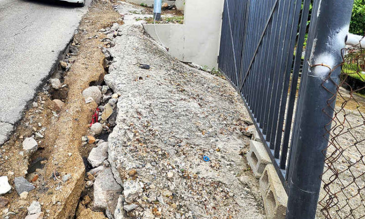 Rain washes away poorly-restored roadside, causing  access problems for Mount Willem Hill residents