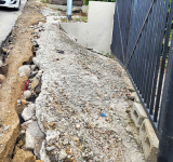 Rain washes away poorly-restored roadside, causing  access problems for Mount Willem Hill residents
