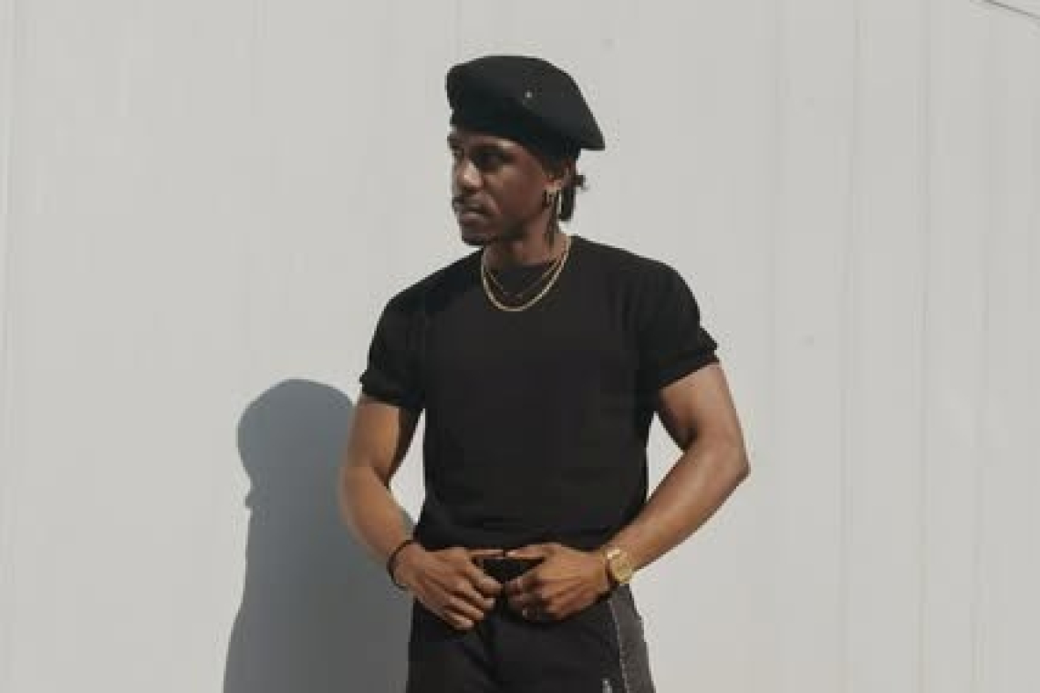     Local dancer Jay Mills flies St. Maarten flag at Super Bowl halftime performance