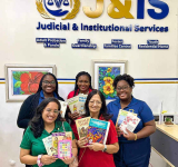Rotary Club Mid Isle gifts  books for children to J&IS