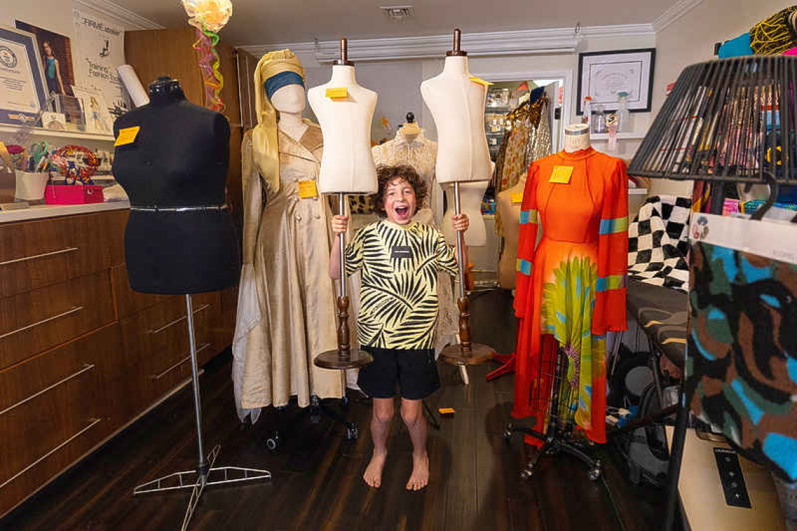 Ten-year-old American fashion designer  shuttles between school and runways