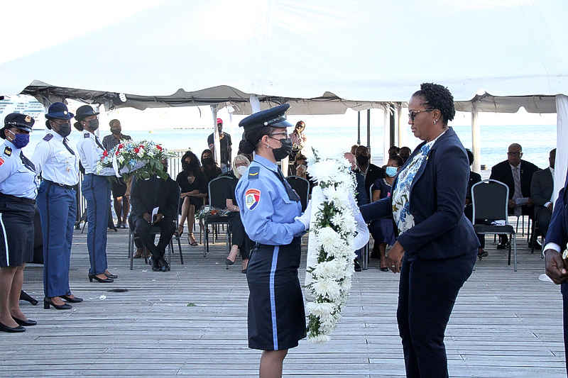 MinAGZ_Natl_Remembrance_Day_Prime_Minister_Silveria_Jacobs_being_given_a_wreath_to_lay_at_the_war_memorial.jpg